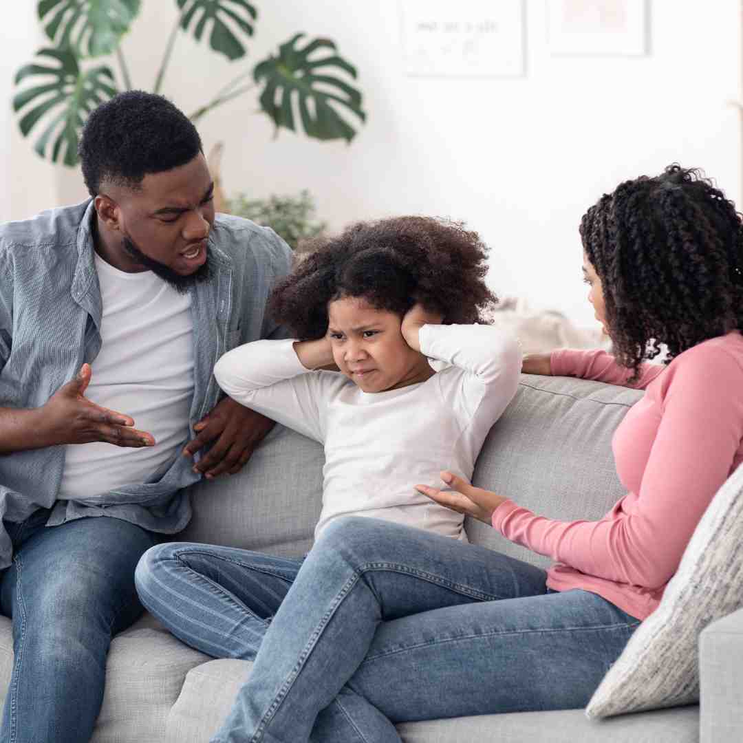 Parents talking to a frustrated young girl, showcasing Evolved Education Company's focus on collaborative parenting solutions and school support for families.